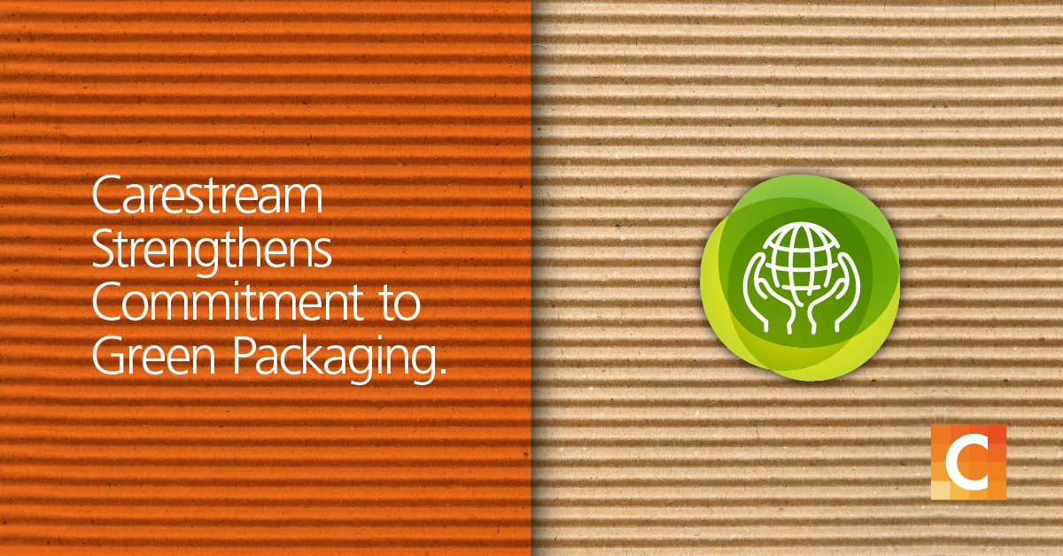 Cardboard backgroud - Half of it is in orange preset with text "Carestream Strengthens Commitment to Green Packaging" with a sustainability icon and Carestream logo. 