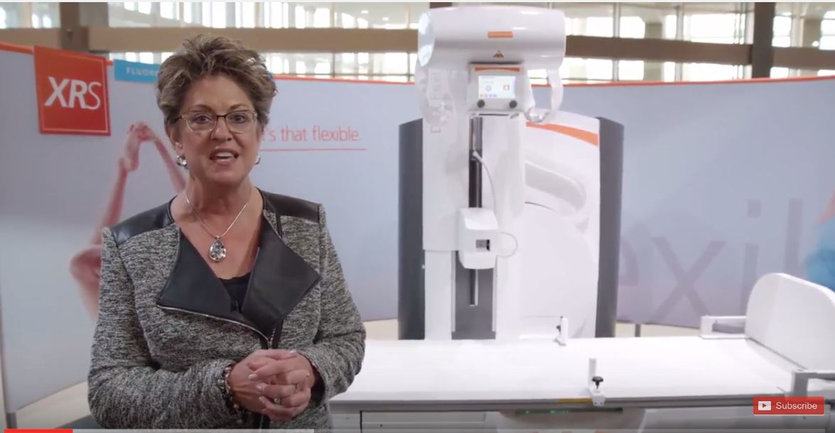 Woman standing in front of Excel Plus machine