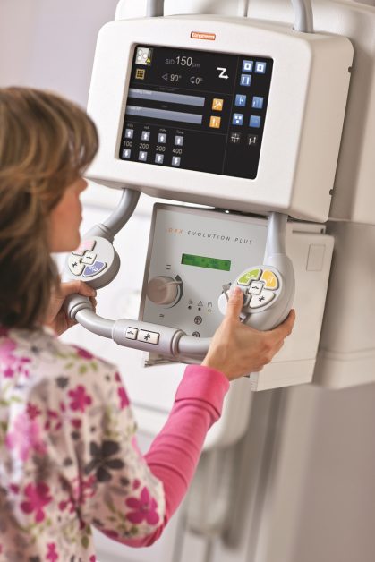 nurse using the collimator on the DRX-Evolution Plus system 