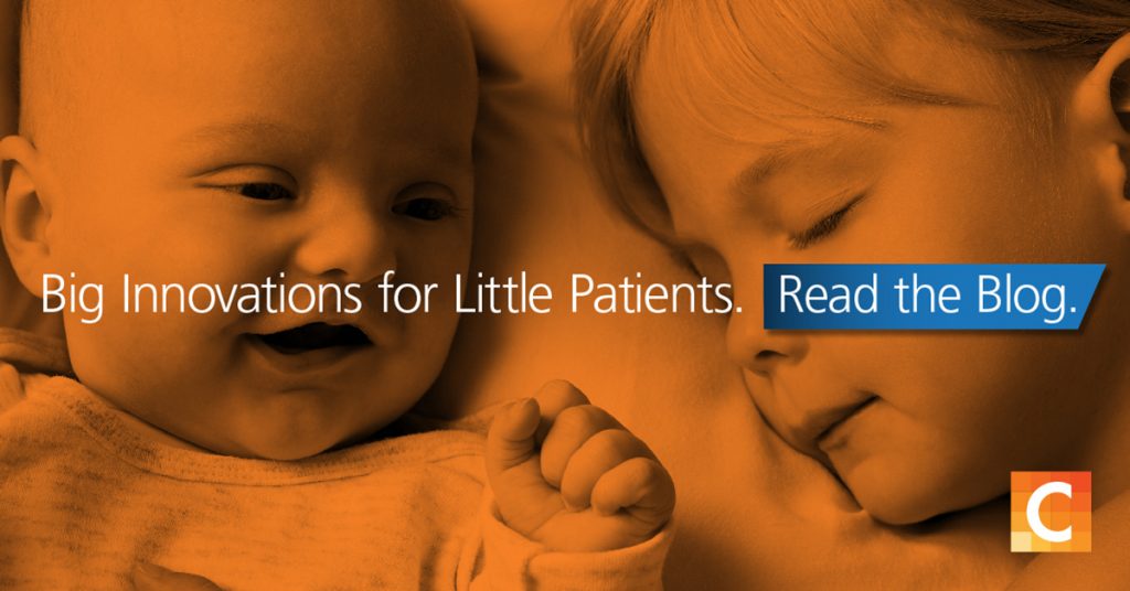 Photo of a baby and young child laying next to each other. Big innovations for little patients written ontop. Carestream logo in bottom right corner.